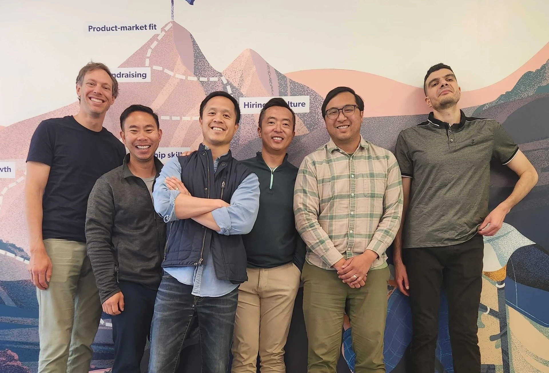 Team photo with colorful mountain backdrop